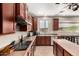 Kitchen features a smooth cooktop, stainless steel sink, and center island at 17005 S Coleman St, Phoenix, AZ 85045