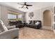 Spacious living room features tile floors, ceiling fan, large window and two sofas at 17005 S Coleman St, Phoenix, AZ 85045