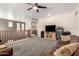 Upstairs Living Room features a ceiling fan, wood railing, carpeted floor, and a television at 17005 S Coleman St, Phoenix, AZ 85045