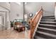 Bright living room featuring a staircase, fire place, fish tank, tile floors and high ceilings at 17005 S Coleman St, Phoenix, AZ 85045