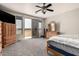 Main bedroom featuring a balcony, carpeted floor, ceiling fan, and wood furniture at 17005 S Coleman St, Phoenix, AZ 85045