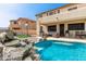 Beautiful pool with a rock waterfall and a covered patio with grill and seating at 17005 S Coleman St, Phoenix, AZ 85045