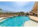 Sparkling backyard pool with rock waterfall feature and covered patio seating area at 17005 S Coleman St, Phoenix, AZ 85045