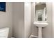 Cozy powder room with pedestal sink and neutral walls, perfect for guests at 17005 S Coleman St, Phoenix, AZ 85045