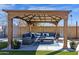 Covered outdoor patio with comfortable seating and a stylish rug for relaxing and entertaining guests at 1715 W Carol Ave, Mesa, AZ 85202