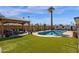 Expansive backyard with pool, patio, and green grass perfect for outdoor living and entertainment at 1715 W Carol Ave, Mesa, AZ 85202