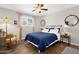 Comfortable bedroom features wood-look floors, neutral paint, and a bright window with natural light at 1715 W Carol Ave, Mesa, AZ 85202