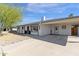 Single-story home with a covered carport, neutral paint, well-maintained landscaping, and inviting curb appeal at 1715 W Carol Ave, Mesa, AZ 85202