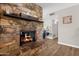 Charming stone fireplace with a wooden mantel and lit candles, creating a warm and inviting atmosphere at 1715 W Carol Ave, Mesa, AZ 85202