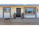 Charming front entrance with flower boxes, a security screen door, and well-maintained gravel landscaping at 1715 W Carol Ave, Mesa, AZ 85202