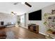 Spacious living room with wood floors, modern decor, and a large television for entertainment at 1715 W Carol Ave, Mesa, AZ 85202