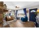 Bright living room with large window, stone fireplace, stylish decor, and comfortable seating, a perfect relaxation space at 1715 W Carol Ave, Mesa, AZ 85202