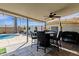 Inviting outdoor patio with a covered dining area, string lights, and a clear view of the sparkling pool at 1715 W Carol Ave, Mesa, AZ 85202