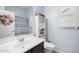 Well-lit bathroom featuring a single vanity, a toilet, and a shower/tub combination with a decorative curtain at 17545 W Lilac St, Goodyear, AZ 85338