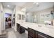 Bright bathroom featuring double sinks, granite countertops, a walk-in shower, and a walk-in closet at 17545 W Lilac St, Goodyear, AZ 85338