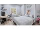 Cozy bedroom with a hanging chair, neutral walls, wood-look floors, and a comfortable bed at 17545 W Lilac St, Goodyear, AZ 85338