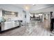 Bright dining room with modern chandelier, transparent furniture, and views to the kitchen at 17545 W Lilac St, Goodyear, AZ 85338