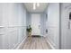 Inviting entryway with light gray walls, decorative wall trim, wood-look floors, and a decorative front door at 17545 W Lilac St, Goodyear, AZ 85338