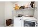 Bright laundry room with modern appliances, shelving, and ample storage space at 17545 W Lilac St, Goodyear, AZ 85338