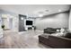 Open-concept living room with modern decor, recessed lighting, and luxury vinyl plank flooring at 17545 W Lilac St, Goodyear, AZ 85338