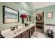 The renovated ensuite bathroom boasts a barn door, dual sinks and updated fixtures at 2167 E Aspen Dr, Tempe, AZ 85282