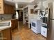 Functional kitchen with white appliances, wood cabinets, and stainless steel refrigerator at 2167 E Aspen Dr, Tempe, AZ 85282