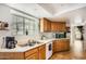 Well-equipped kitchen featuring tile floors, laminate countertops, and a stainless steel sink at 2167 E Aspen Dr, Tempe, AZ 85282