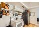 Well-lit kitchen featuring an oven, overhead hood, stainless steel refrigerator, and tile floor at 2167 E Aspen Dr, Tempe, AZ 85282