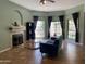 Cozy living room with fireplace, tile floors, and natural light from large windows at 2167 E Aspen Dr, Tempe, AZ 85282