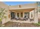 Covered patio is perfect for enjoying the backyard with outdoor seating and charming decor at 2167 E Aspen Dr, Tempe, AZ 85282