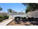 Community tennis and basketball courts surrounded by tall privacy fence and mature trees at 2167 E Aspen Dr, Tempe, AZ 85282
