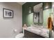 Stylish bathroom with a modern vanity, decorative mirror, and pendant lighting at 2211 E Camelback Rd # 605, Phoenix, AZ 85016