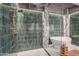 Contemporary bathroom showcasing a glass-enclosed shower, luxurious emerald tiles, and a standalone tub for ultimate relaxation at 2211 E Camelback Rd # 605, Phoenix, AZ 85016