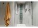 Modern shower featuring stone tiling, a niche for toiletries, and a sleek glass enclosure at 2211 E Camelback Rd # 605, Phoenix, AZ 85016