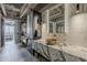 Elegant bathroom boasting dual vanities with marble countertops, unique vessel sinks, and contemporary lighting fixtures at 2211 E Camelback Rd # 605, Phoenix, AZ 85016