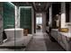 Spa-like bathroom with green tile, a soaking tub, marble vanity, and modern fixtures at 2211 E Camelback Rd # 605, Phoenix, AZ 85016
