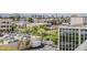 Expansive cityscape view showcasing parking and mature trees with the outline of mountains visible in the background at 2211 E Camelback Rd # 605, Phoenix, AZ 85016