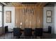 Stylish dining area with a glass table, modern lighting fixture, and decorative wall paneling at 2211 E Camelback Rd # 605, Phoenix, AZ 85016