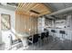 Dining area with a view of a kitchen, featuring a glass table, modern chairs and wood slats at 2211 E Camelback Rd # 605, Phoenix, AZ 85016