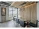 Modern dining room with a glass table, leather chairs, and a large window showcasing city views at 2211 E Camelback Rd # 605, Phoenix, AZ 85016