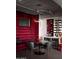 Unique dining space featuring a red velvet bench, a wine rack, and contemporary lighting at 2211 E Camelback Rd # 605, Phoenix, AZ 85016