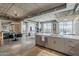 Open-concept kitchen with an island, stainless steel appliances, and a dining area, showcasing modern design at 2211 E Camelback Rd # 605, Phoenix, AZ 85016