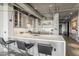 Open kitchen with a bar, stainless steel appliances, and exposed ceiling pipes at 2211 E Camelback Rd # 605, Phoenix, AZ 85016