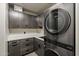 Well-organized laundry room with modern washer and dryer units, ample counter space, and sleek cabinetry at 2211 E Camelback Rd # 605, Phoenix, AZ 85016