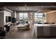 Modern living room with hardwood floors, fireplace, and city views from expansive windows at 2211 E Camelback Rd # 605, Phoenix, AZ 85016