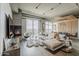 Expansive living area with fireplace, plush seating, balcony access, and panoramic city views at 2211 E Camelback Rd # 605, Phoenix, AZ 85016