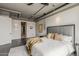 Spacious main bedroom with comfortable bedding, stylish decor, and a view into the home's ensuite bathroom and closet at 2211 E Camelback Rd # 605, Phoenix, AZ 85016