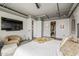 Bright, well-appointed main bedroom with TV, with views to ensuite bathroom and closet at 2211 E Camelback Rd # 605, Phoenix, AZ 85016