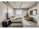 Relaxing main bedroom features a sitting area, sleek lighting, and large windows for natural light and city views at 2211 E Camelback Rd # 605, Phoenix, AZ 85016