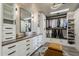 Spacious walk-in closet featuring custom storage, drawers, shelving, and a large dressing mirror at 2211 E Camelback Rd # 605, Phoenix, AZ 85016